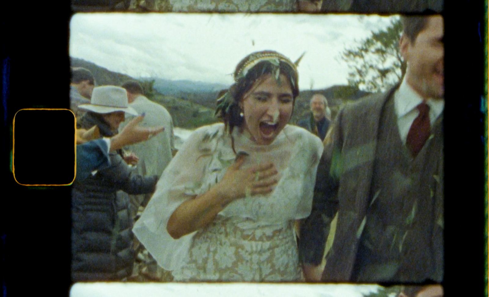 Bride mid-scream at the camera, shot by a guest