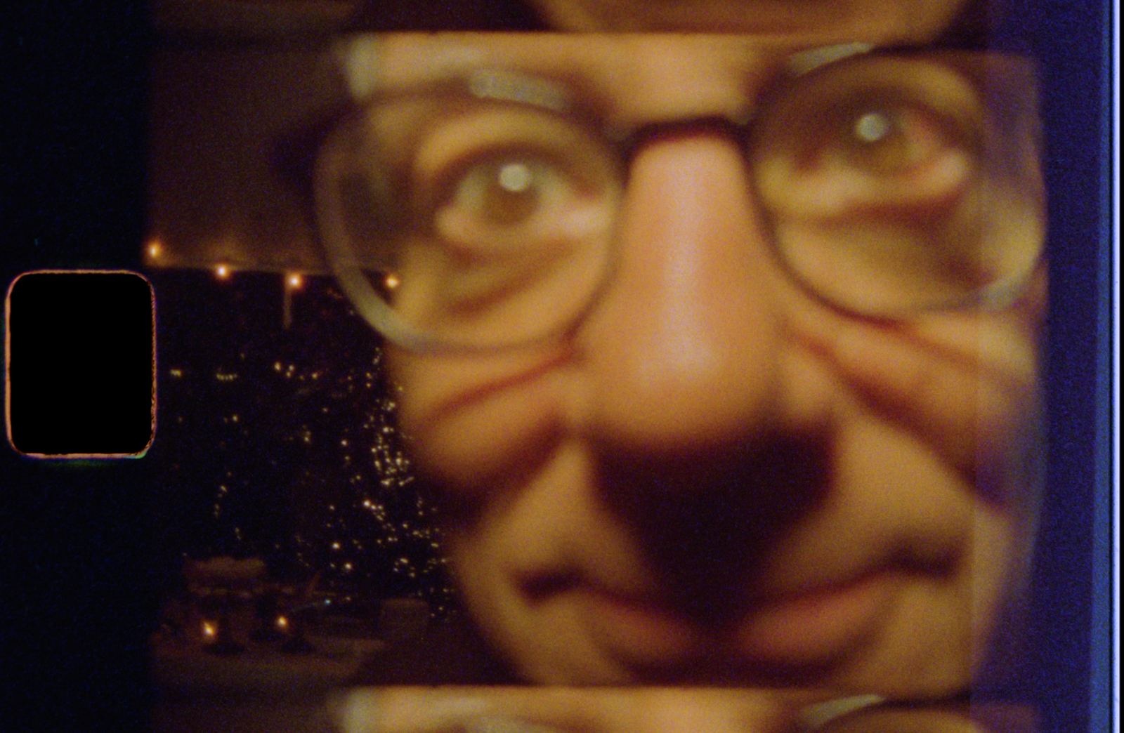 A guest grinning inches from the lens