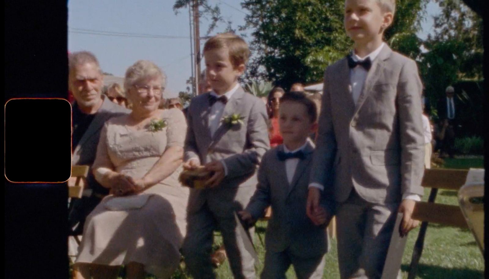 Ring bearers walking the aisle, shot by a guest